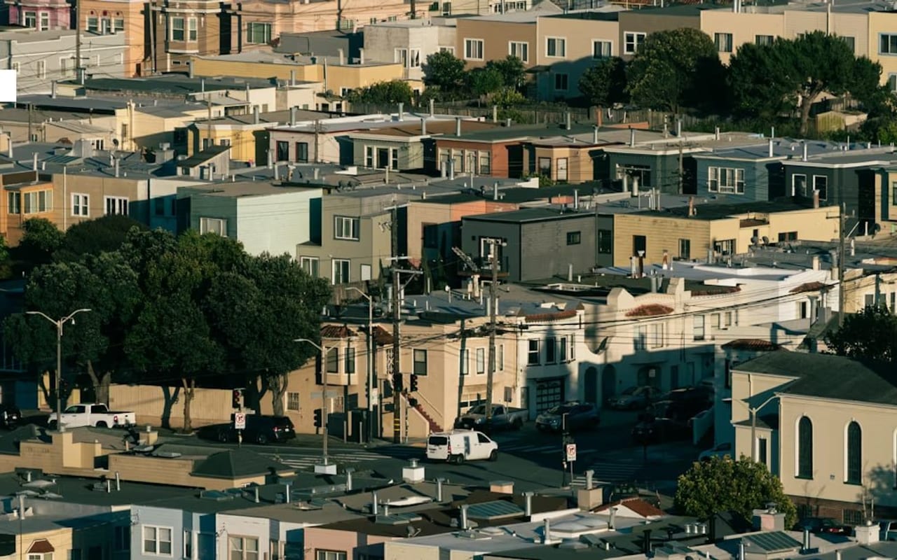 Dense urban neighborhood of closely packed homes at golden hour